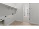 Laundry room with washer/dryer hookups and shelving with an open doorway to a closet at 12327 W Luxton Ln, Avondale, AZ 85323