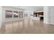 Bright, open-concept living room featuring tile floors, ample windows and access to the kitchen at 12327 W Luxton Ln, Avondale, AZ 85323