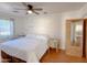 Bright bedroom features wood floors, a ceiling fan, and closet at 1342 N Mckenna Ln, Gilbert, AZ 85233