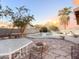 Backyard pool is surrounded by a stone patio and landscaping at 1342 N Mckenna Ln, Gilbert, AZ 85233