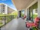 Large balcony with chairs and potted plants, offering views of the city and lush trees at 14850 E Grandview Dr # 204, Fountain Hills, AZ 85268