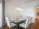 Elegant dining room featuring a glass-top table, seating for six, and stylish chandelier lighting at 14850 E Grandview Dr # 204, Fountain Hills, AZ 85268