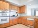 Well-lit kitchen features wood cabinets, tile flooring, and standard appliances for a functional cooking space at 14850 E Grandview Dr # 204, Fountain Hills, AZ 85268