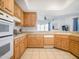 Well-equipped kitchen featuring wood cabinets, tile flooring, and standard appliances at 14850 E Grandview Dr # 204, Fountain Hills, AZ 85268