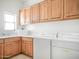 Functional laundry room with ample cabinet space, a sink, and modern washer and dryer at 14850 E Grandview Dr # 204, Fountain Hills, AZ 85268