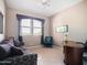 Cozy living room with a comfortable sofa, accent chair, and a well-lit desk area at 14850 E Grandview Dr # 204, Fountain Hills, AZ 85268
