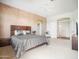 Spacious main bedroom features a neutral color palette, ceiling fan, and doorway to another room at 14850 E Grandview Dr # 204, Fountain Hills, AZ 85268