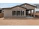 Rear exterior view showing patio, windows, and backyard space of the home at 22762 E Stacey Rd, Queen Creek, AZ 85142