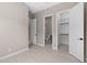 Bright bedroom with closet and bathroom featuring neutral walls and light wood-look floors at 22762 E Stacey Rd, Queen Creek, AZ 85142