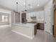 Open kitchen layout featuring a spacious island, white cabinets, modern appliances, and pendant lighting at 22762 E Stacey Rd, Queen Creek, AZ 85142