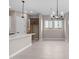 Open kitchen area featuring white cabinets, quartz countertops, tile backsplash, and a modern chandelier at 22762 E Stacey Rd, Queen Creek, AZ 85142