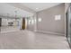 Spacious living area featuring tile flooring, recessed lighting, large windows, and an open layout to the kitchen at 22762 E Stacey Rd, Queen Creek, AZ 85142