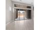 Bright living room with a large glass sliding door that leads to the backyard and light-colored tile floors at 22762 E Stacey Rd, Queen Creek, AZ 85142