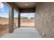 Covered patio overlooking backyard with concrete floor, neutral stucco columns, and backyard view at 22762 E Stacey Rd, Queen Creek, AZ 85142