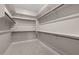 Walk-in closet with wood flooring and multiple shelves and rods for optimal storage at 22762 E Stacey Rd, Queen Creek, AZ 85142