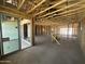 Unfinished home interior showcasing exposed framing, concrete floors, and sliding glass doors at 2328 E Spur Dr, San Tan Valley, AZ 85140