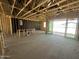 Unfinished home interior with exposed framing, sliding glass doors, and concrete floors at 2328 E Spur Dr, San Tan Valley, AZ 85140