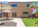 A well-maintained backyard featuring a patio, lawn, a sliding glass door, and flowering plants at 2565 E Southern Ave # 130, Mesa, AZ 85204