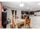 Cozy dining area with a wooden table, chairs, and modern lighting at 2565 E Southern Ave # 130, Mesa, AZ 85204