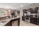 Open kitchen featuring stainless steel appliances, dark cabinetry, and spacious counters at 2565 E Southern Ave # 130, Mesa, AZ 85204
