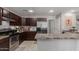 Well-equipped kitchen with stainless steel appliances and dark wood cabinets at 2565 E Southern Ave # 130, Mesa, AZ 85204