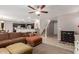 Open living area with tile flooring, a sectional sofa, and an adjacent kitchen at 2565 E Southern Ave # 130, Mesa, AZ 85204