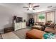 Cozy living room featuring a ceiling fan, a television, and comfortable seating at 2565 E Southern Ave # 130, Mesa, AZ 85204