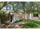 Backyard with a playhouse, a covered patio with a swing, mature trees, and green lawn at 2821 E Pontiac Dr, Phoenix, AZ 85050