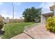 Spacious backyard with a lush lawn, mature trees, colorful flowers, and a charming tiled patio at 2821 E Pontiac Dr, Phoenix, AZ 85050