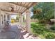 Charming covered patio with a ceiling fan, swing, and a lush green lawn perfect for outdoor enjoyment at 2821 E Pontiac Dr, Phoenix, AZ 85050