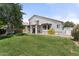 Expansive backyard featuring a lush lawn, playhouse, mature tree, and covered patio, ideal for relaxation at 2821 E Pontiac Dr, Phoenix, AZ 85050
