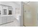 Bright bathroom featuring double sinks with a large mirror and glass-enclosed shower at 2821 E Pontiac Dr, Phoenix, AZ 85050