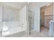 This bathroom offers a soaking tub, glass shower, and walk-in closet with built-in shelves at 2821 E Pontiac Dr, Phoenix, AZ 85050