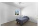 Bedroom features carpet, a ceiling fan, a window with blinds, and an electrical outlet at 2821 E Pontiac Dr, Phoenix, AZ 85050