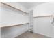 Walk-in closet featuring built-in storage shelves and hanging rods to maximize storage space at 2821 E Pontiac Dr, Phoenix, AZ 85050