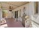 Covered patio with a stainless steel gas grill, rocking chair, and ceiling fan perfect for outdoor living at 2821 E Pontiac Dr, Phoenix, AZ 85050