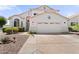 Charming single-story home featuring a two-car garage, lush landscaping, and a welcoming entrance, and a driveway at 2821 E Pontiac Dr, Phoenix, AZ 85050