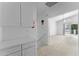 Bright hallway with cabinets leading to a large living room with a balcony at 2821 E Pontiac Dr, Phoenix, AZ 85050