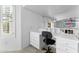Upstairs home office featuring built-in desk, drawers, and ample natural light at 2821 E Pontiac Dr, Phoenix, AZ 85050