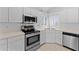 Bright kitchen with white cabinets, stainless steel appliances, and ample counter space at 2821 E Pontiac Dr, Phoenix, AZ 85050