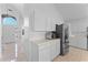 Bright kitchen featuring white cabinets, stainless steel appliances, and an open view to the entryway at 2821 E Pontiac Dr, Phoenix, AZ 85050