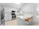 Bright kitchen with white cabinets, stainless steel appliances, breakfast bar, and ample counter space at 2821 E Pontiac Dr, Phoenix, AZ 85050