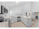 Bright kitchen featuring white cabinets, stainless steel appliances, breakfast bar, and ample counter space at 2821 E Pontiac Dr, Phoenix, AZ 85050