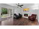 Cozy living room featuring wood floors, fireplace, and access to the backyard at 2821 E Pontiac Dr, Phoenix, AZ 85050