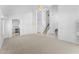 Spacious living room featuring high ceilings, and an open floor plan leading to the kitchen and staircase at 2821 E Pontiac Dr, Phoenix, AZ 85050