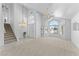 Bright and airy living room featuring vaulted ceilings, arched windows, and a staircase at 2821 E Pontiac Dr, Phoenix, AZ 85050