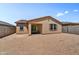 View of back patio area of home with stucco exterior and tan trim at 31345 N 130Th Ave, Peoria, AZ 85383