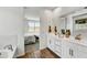 Bright bathroom with double sink vanity and a glimpse into the relaxing bedroom at 31345 N 130Th Ave, Peoria, AZ 85383