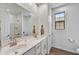 Bathroom featuring a double sink vanity with white cabinetry and tile-look floors at 31345 N 130Th Ave, Peoria, AZ 85383