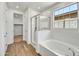 Beautiful bathroom with a separate shower, tub, and easy access to a walk-in closet at 31345 N 130Th Ave, Peoria, AZ 85383